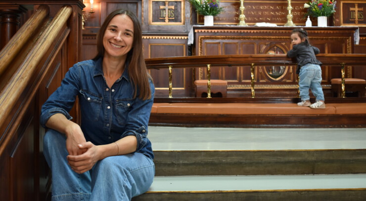 olga sits in front of the altar in the eliaskirke in copenhagen